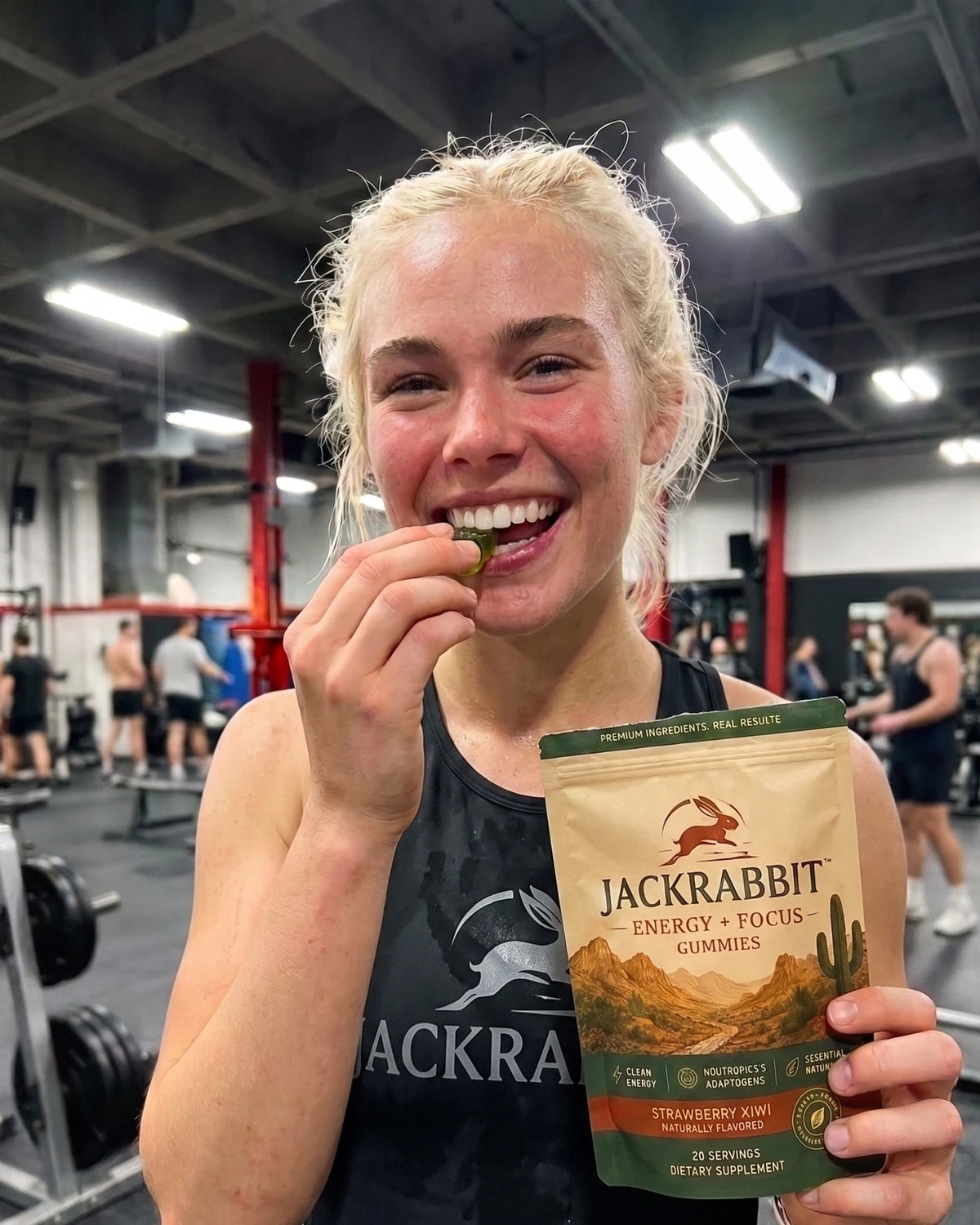 Athlete taking a Jackrabbit gummy at the gym